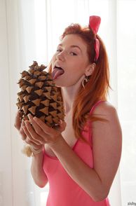 Red Head Cutie Licking A Pine Cone